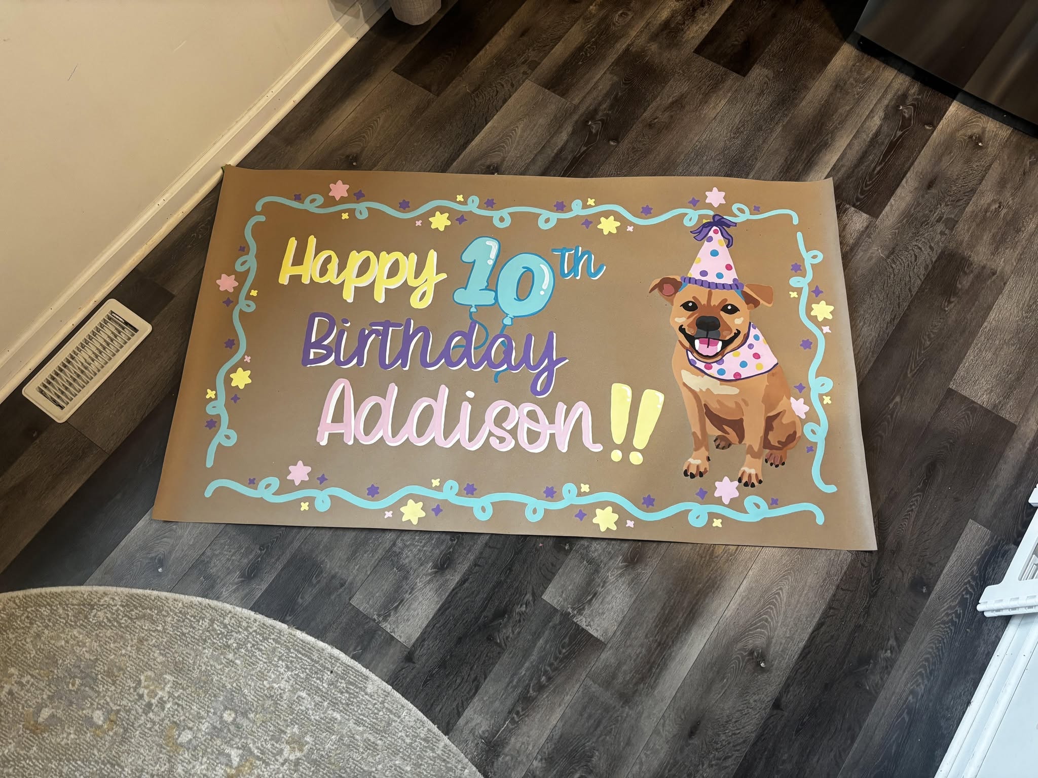 'Happy 10th Birthday Addison' banner with a hand-painted dog in a party hat